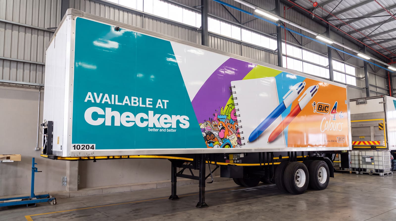 Large-format trailer graphics advertising BIC stationery, available at Checkers