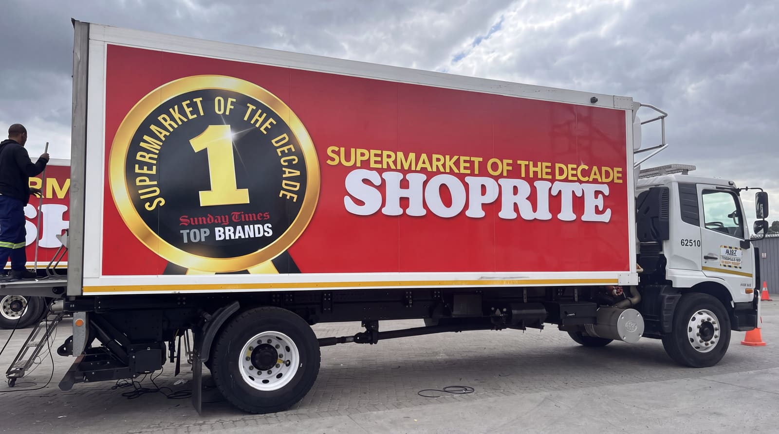 Large-format branded trailer graphics reading Supermarket of the Decade, Shoprite