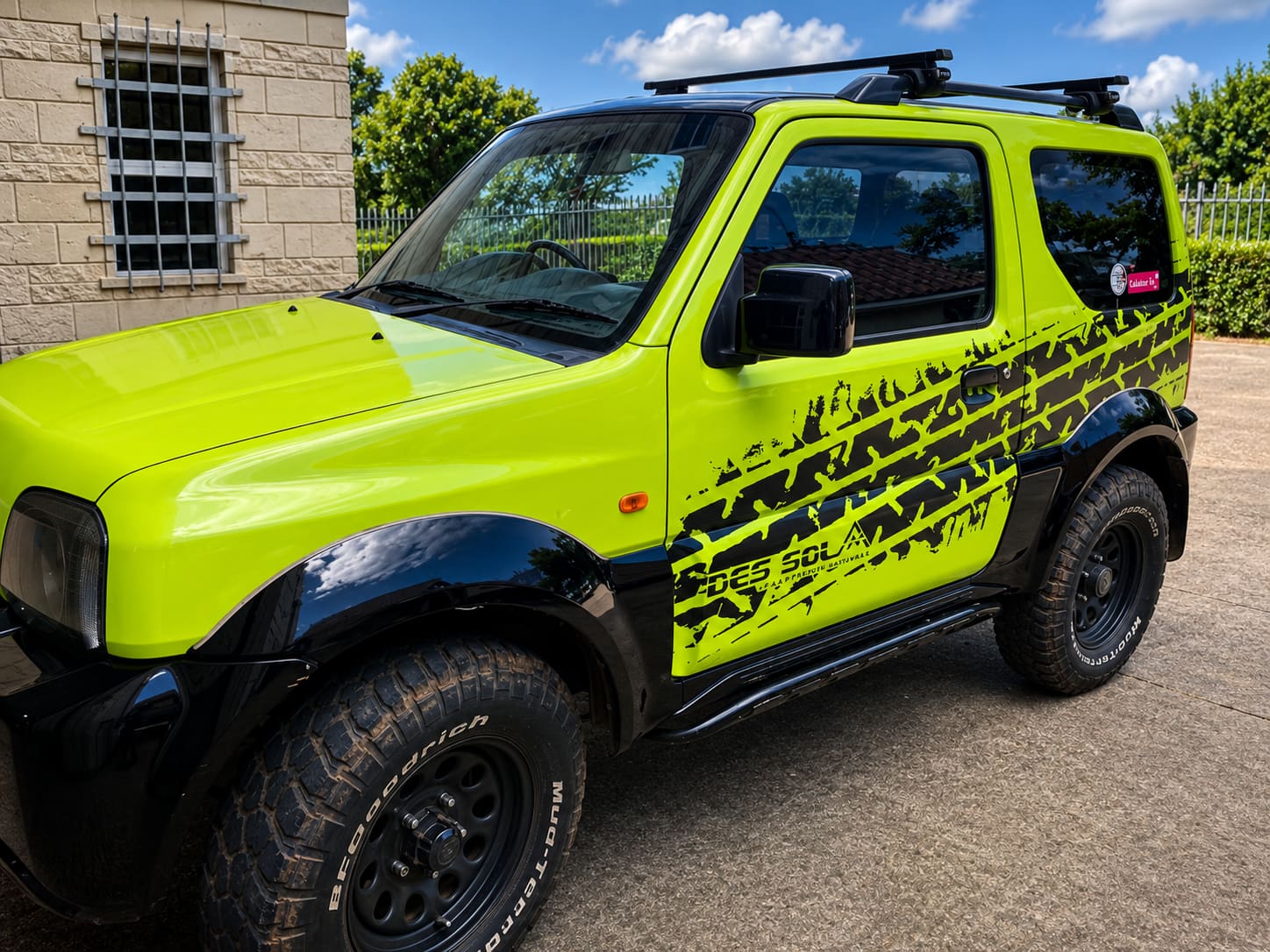 Lime green Suzuki Jimny with a tyre-tread pattern vehicle wrap